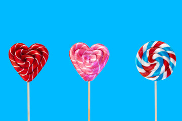 Lollipops on a blue background. Isolate Sweets on a stick.