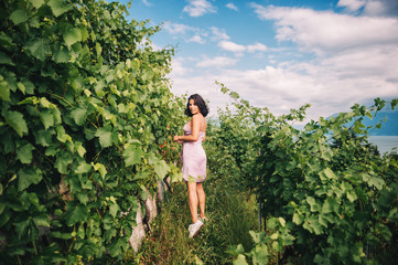 Summer portrait of happy young woman hiking in vinyards