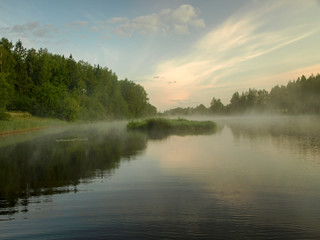 landscape with lake, early morning, mysterious mist rising from the surface of the water