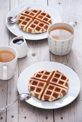 Breakfast - waffles and tea on a wooden table