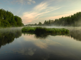 landscape with lake, early morning, mysterious mist rising from the surface of the water