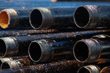 Close up drill pipe thread with pipe dope grease lay down on rig floor at oil and gas on shore location.