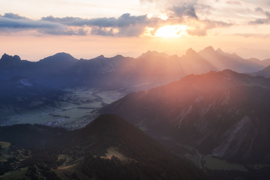 Sunlight bursts through the clouds in the austrian alps in tannheimer tal near vilsalpsee, reutte, tyrol. Valley, From top of the mountain gaishorn