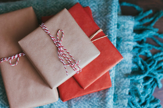 Stack of wrapped Christmas presents on a blanket