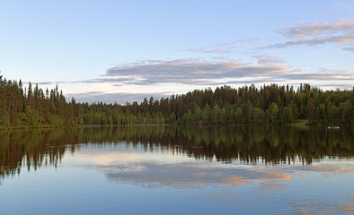 Fototapeta na wymiar Beautiful sunset on Talvijarvi Lake in Ruka, Lapland, Finland. Summer night