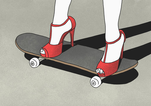 Low section of woman wearing high heels and standing on skateboard