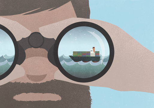 Reflection of a ship in binoculars held by a man with a beard