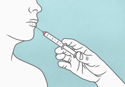 Detail of hand using syringe to make injection in womans lips