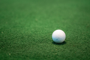 Close-up golf ball on the driving range for practice.