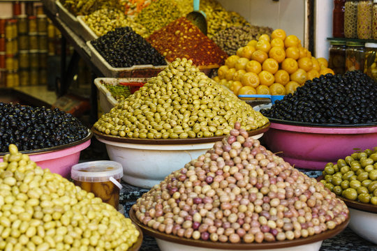 Abundant variety of fresh olives on display in souk market stall, Marrakesh, Morocco