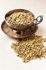 green coffee beans on antique bowl, cup 
