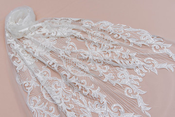 Obraz premium Texture lace fabric. lace on white background studio. thin fabric made of yarn or thread. a background image of ivory-colored lace cloth. White lace on beige background.