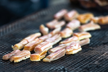 Grilled fish. Cooking fish by Italian chefs. Pieces of raw fish languish on the grill.