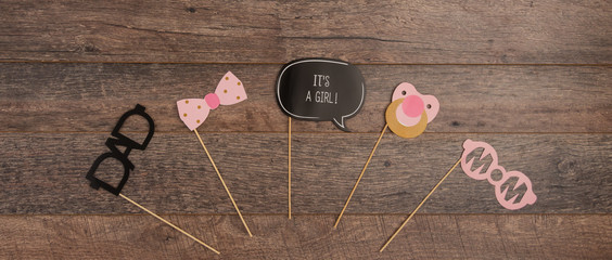 Baby christening photo booth props on wooden background