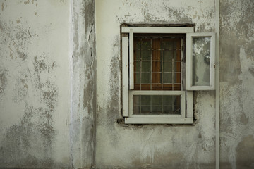 Old vintage wall with wooden window with grill