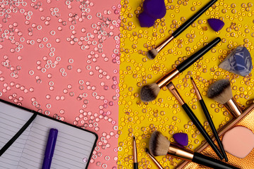 Violet marker and notebook with cosmetic accessories, top view
