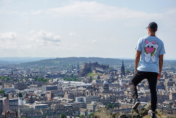 Fototapeta na wymiar Guy admiring the Edinburg Skyline.
