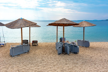 Umbrellas and sunbeds on Toroni beach, Sithonia, Chalkidiki, Greece