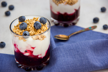 Glass of muesli and yogurt with fresh berries