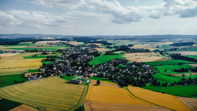 Drone point of view sunny view farmland and rural townscape, Bayern, Germany