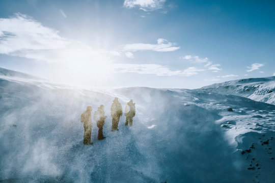 Men hiking in snow covered landscape