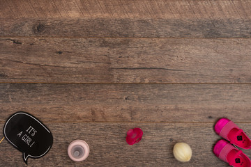 Pacifier with baby girl christening accessories on wooden background