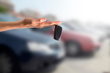 hand holding car keys, buy and rent car