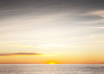 sun coming up over the sea