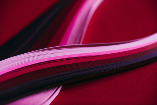 Abstract rainbow paper wave pattern on red background