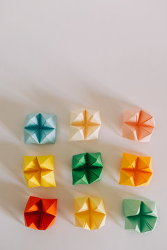 Multicolored origami fortune tellers on white background