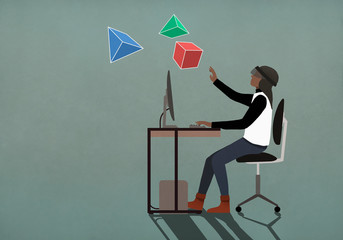 Computer programmer with virtual reality simulator glasses looking at 3D geometric shapes