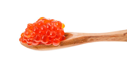 side view of little wooden spoon with red caviar