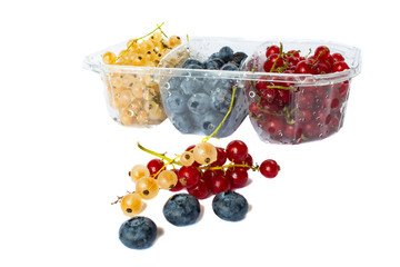 berries of red and white currants and blueberries in plastic packaging.