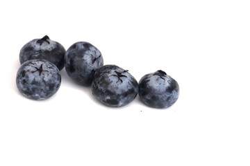 In selective focus a group of fresh blueberries on white isolated background