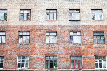 Fototapeta na wymiar facade of shabby wall of multistorey brick house