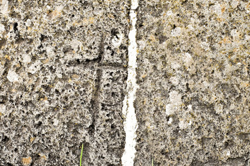 Cross symbol carved in old stone element. Medieval Christian symbolism.