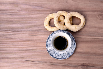 cup of coffee with cookie on table with background