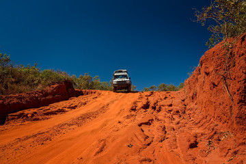 Western Australia – Outback track with 4WD car downhill to the ocean at Dampier Peninsula