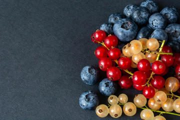 berries of red and white currants and blueberries in plastic packaging.
