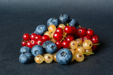 berries of red and white currants and blueberries in plastic packaging.