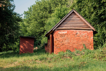 Red brick shed with wooden roof covered with slate