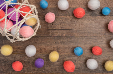 Scattered colorful yarn balls on flat lay, top view