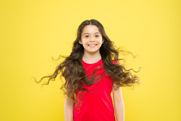 Hairdresser tip. Kid girl long healthy shiny hair. Perfect curls. Kid cute face with adorable curly hairstyle. Little girl grow long hair. Teen fashion model. Discover difference. Styling curly hair