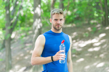 Taking break. man in sportswear drink water. refreshing vitamin drink after workout. athletic man with water bottle. Athlete drink water after training in park. care body hydration. sport and health