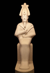 Statue of Osiris isolated on black. He was son of Ra, lord of the dead and rebirth, god of fertility in ancient Egypt.