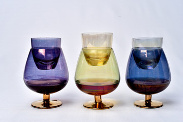 Colorful drinks glass cup on table on white background