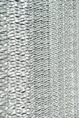 Metallic netting. Protective material. Metal recycling. Metallic screen. Industrial concept. Iron producing. Sharp metallic texture. Silver foil background. Metal surface lathing