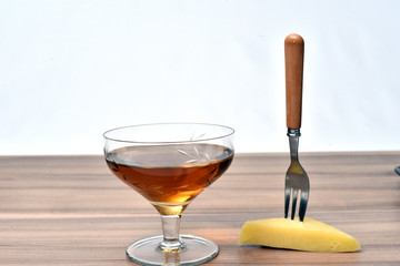glass of alcoholic drink with cheese on the table on white background