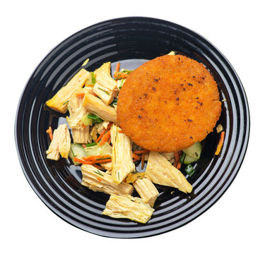 fishcake with soy asparagus and carrots, cucumbers and dilll.  fish cutlet on a plate isolated. cutlet with vegetables top view