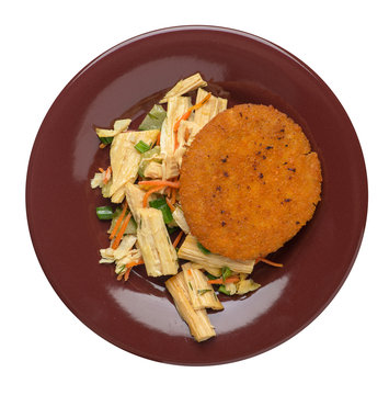 fishcake with soy asparagus and carrots, cucumbers and dilll.  fish cutlet on a plate isolated. cutlet with vegetables top view